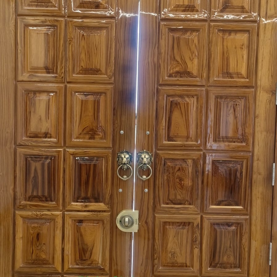 Polished teak double door with raised square panels and lion-head brass handles, glossy finish