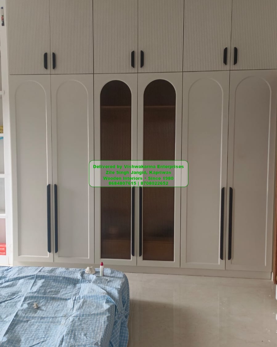 Six-door white wardrobe with arched fluted glass centre panels and matte black handles